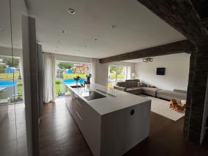 a kitchen and living room with a couch and a table at Casa Stein am Rhein inkl Pool in Stein am Rhein