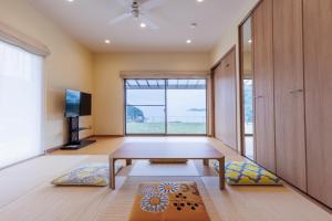 a living room with a table and a large window at ヴィラ倉橋 in Kure +45 photos