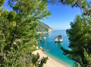 a view of a beach with rocks in the water at AH Premium Baia dei Faraglioni in Mattinata