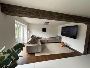 a living room with a couch and a flat screen tv at Casa Stein am Rhein inkl Pool in Stein am Rhein +3 photos