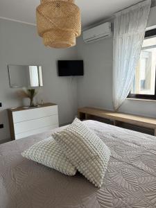 a bedroom with a bed with a pillow on it at Domus Relax in Battipaglia