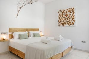 a bedroom with a large white bed with two pillows at Can Drago in Ibiza Town +28 photos