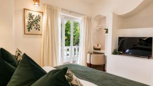 a bedroom with a bed and a window at White Coco Luxury Villas, Private Pool, North Goa in Baga