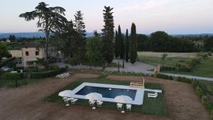 an aerial view of a house with a swimming pool at Villa Arnolfo in Colle di Val d'Elsa
