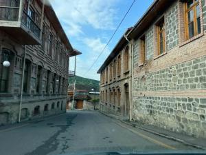 an empty street in an old town with buildings at Cozy house in Sheki