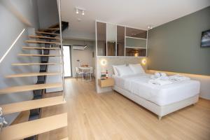 a bedroom with a white bed and a staircase at iMa-Ge Luxury in Nea Vrasna +30 photos