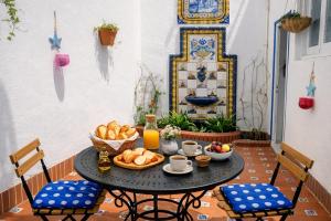 a table with a bowl of bread and fruit on it at La Casa de la Punta in San Pol de Mar +34 photos