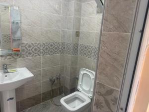 a bathroom with a toilet and a sink at Cozy house in Sheki