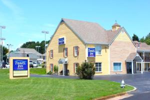 a house with blue signs on the side of it at Travel Inn Buford near Mall of Georgia in Buford