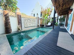 a swimming pool next to a house at Beachview Villa near Sanur, Live Sports AFL NRL in Ketewel