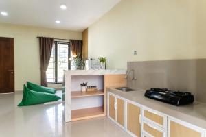 a kitchen with a sink and a counter top at Calma Villa Panorama, Batu Malang in Batu +21 photos