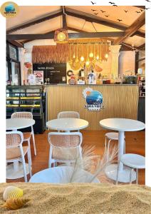 a couple of tables and chairs in a restaurant at Aqua Vista Merang in Kampung Merang