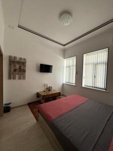 a bedroom with a bed and a television in it at KAMIR Guest House in Bukhara