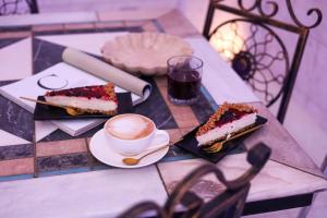 a table with two slices of cake and a cup of coffee at Relais V&G in Anagni +76 photos