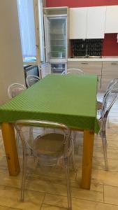 a green table and chairs in a kitchen at Megaride's dépendance in Como +45 photos