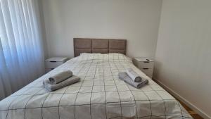 a bedroom with a bed with two pillows on it at MyPlace apartmani 8 in Tuzla