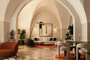 a living room with a couch and chairs and a table at Patria Palace Lecce - The Leading Hotels of The World in Lecce
