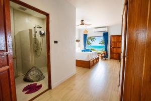 a bathroom with a shower and a bedroom with a bed at Crystal Bay Beach Resort in Lamai