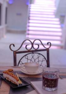 a table with a plate of food and a cup of coffee at Relais V&G in Anagni