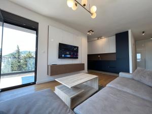 a living room with a couch and a table at 1bd New and Modern Apt with Sea View "Blue Horizon" in Bar +6 photos