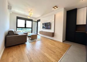 a living room with a couch and a table at 1bd New and Modern Apt with Sea View "Blue Horizon" in Bar