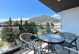 a table and chairs on a balcony with a view at 1bd New and Modern Apt with Sea View "Blue Horizon" in Bar