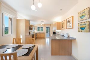 a kitchen and dining room with a table and chairs at San Roque Golf Apartment in San Roque