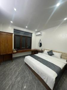a bedroom with a large bed and a window at Cloudy Hotel in Ha Giang +1 photo