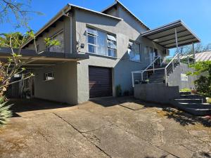 a house with a garage and a driveway at The Calm Views Holiday Home in Hazyview