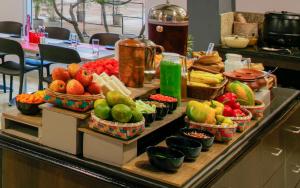 a buffet with fruits and vegetables in baskets on a counter at Ginger Gurugram, Sector 1 in Gurgaon