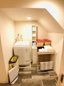 a room with an attic with a sink and a laundry room at Nagoya Minpaku, KANAYAMA BASE in Mutsunochō +32 photos