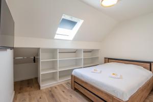 a bedroom with a bed and a skylight at Beautiful and spacious renovated home for 10 in Ostend
