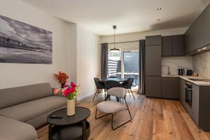 a living room with a couch and a table at Beautiful and spacious renovated home for 10 in Ostend