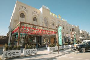 a store front of a building on a street at Dendi hotel bukhara in Bukhara