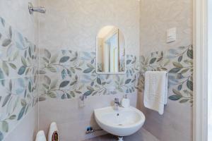 a bathroom with a sink and a mirror at Casamicciola Rooms in Casamicciola Terme