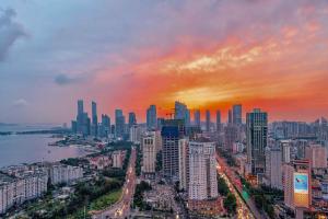 a view of a city skyline with a sunset at Crowne Plaza Qingdao by IHG in Qingdao