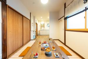 a living room with a table with food on it at Kamenoya, 羽田空港&ディズニー直通バス,2トイレ,亀有駅徒歩7分 in Tokyo