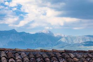 a view of mountains from the roof of a building at La Ruetta in LʼAquila