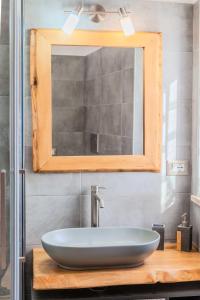 a bathroom with a sink and a mirror at La Ruetta in LʼAquila +12 photos