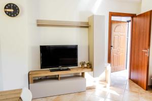a living room with a flat screen tv on a wall at La Ruetta in LʼAquila