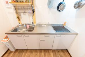 a small kitchen with a sink and a stove at Kamenoya, 羽田空港&ディズニー直通バス,2トイレ,亀有駅徒歩7分 in Tokyo +31 photos
