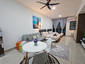 a living room with a couch and a table at Alinea Suites Shah Alam in Shah Alam