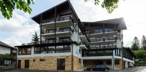 a building with a car parked in front of it at Hotel Margaritar in Buşteni