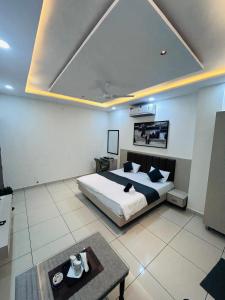 a bedroom with a bed and a tv on the ceiling at hotel capetown in Sirsa +2 photos