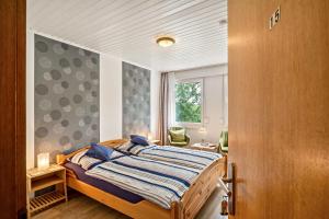 a bedroom with a bed and a window at Haus Hermes in Kirchhundem