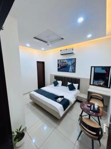 a bedroom with a bed and a tv and a table at hotel capetown in Sirsa