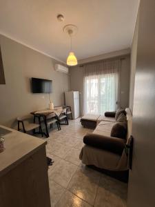 a living room with a couch and a table at Home Sweet Home AXD in Alexandroupoli