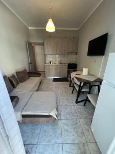 a living room with a couch and a table at Home Sweet Home AXD in Alexandroupoli