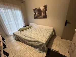 a bedroom with a bed and a cross on the wall at Home Sweet Home AXD in Alexandroupoli