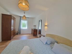 a bedroom with a bed and a dresser in it at Gite De Sandra #Confort in Olby